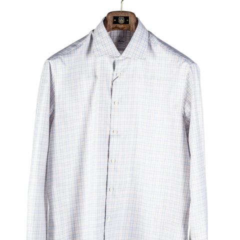 A long-sleeve button-up dress shirt with a fine light blue and white windowpane plaid pattern, hanging on a wooden hanger against a plain light gray background.