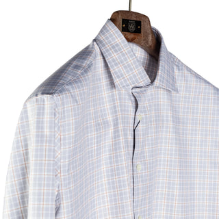 A light blue and white plaid button-down shirt hanging on a wooden hanger against a neutral light gray background.