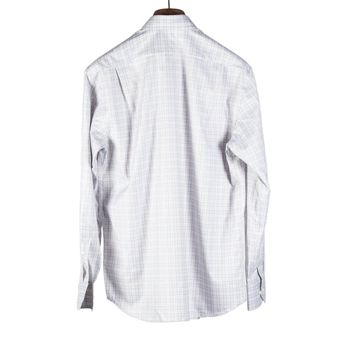 A long-sleeve button-up shirt with a fine white and light blue checkered pattern, shown from the back on a hanger against a light gray background.