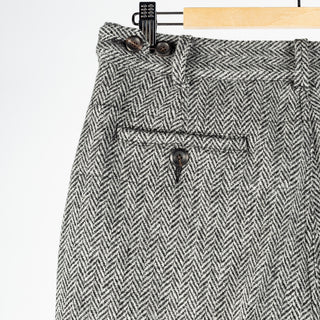 Drake's Harris Tweed One Pleat Games Trousers, back pocket with a button closure in close view.