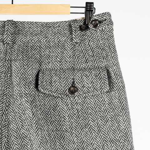 Drake's Harris Tweed One Pleat Games Trousers, flapped back pocket and waistband tab up close.