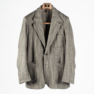 Drake's Black and White Tweed Western Games Blazer shown front on and buttoned on a wooden hanger.
