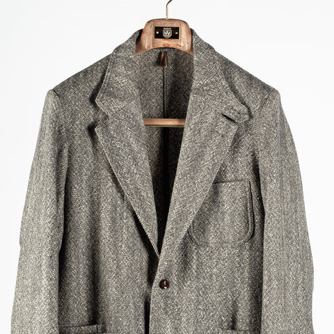 Drake's Black and White Tweed Western Games Blazer, notch lapel and patch chest pocket in close view.