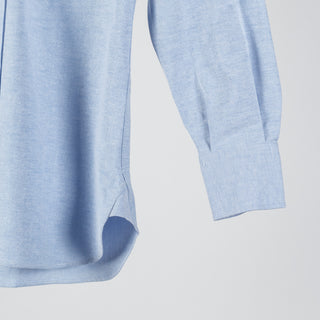 Drake's ice blue oxford cloth button-down shirt from the side, showing the sleeve and single rounded cuff.