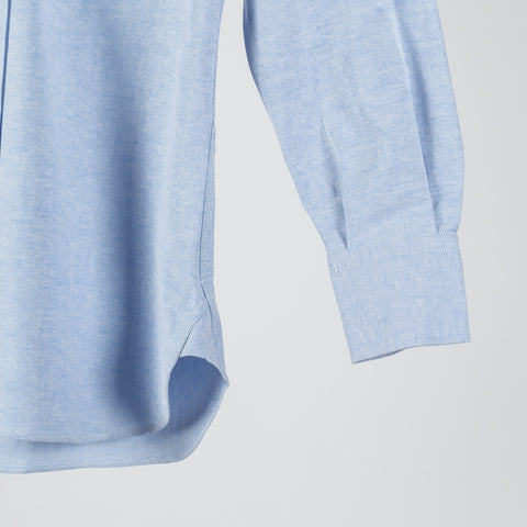 Drake's ice blue oxford cloth button-down shirt from the side, showing the sleeve and single rounded cuff.