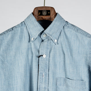 Drake's light blue chambray button-down shirt in close up, with the collar points buttoned down over the placket.