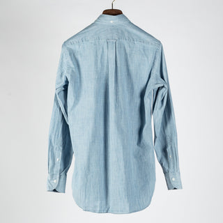 Drake's light blue chambray button-down shirt from the back, showing the box pleat at the yoke.