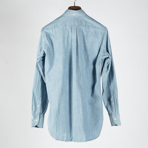 Drake's light blue chambray button-down shirt from the back, showing the box pleat at the yoke.