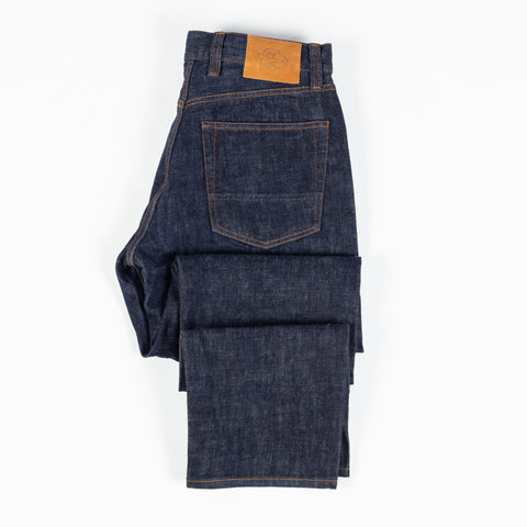 Drake's Indigo Rinse Selvedge Jeans folded flat showing the leather patch and back pocket.