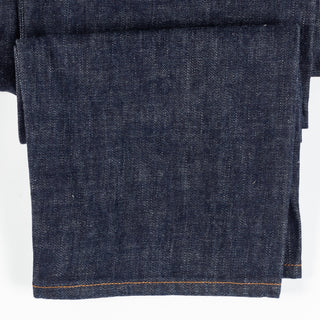 Close detail of the 14.2 oz Japanese selvedge denim and hem stitching on Drake's five-pocket jeans.