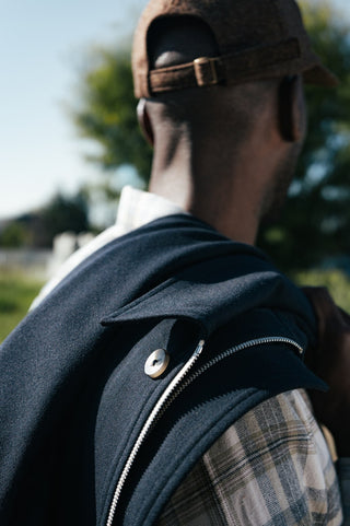 Shoulder and snap detail of the De Bonne Facture Driver'\''s Jacket in navy water-repellent wool