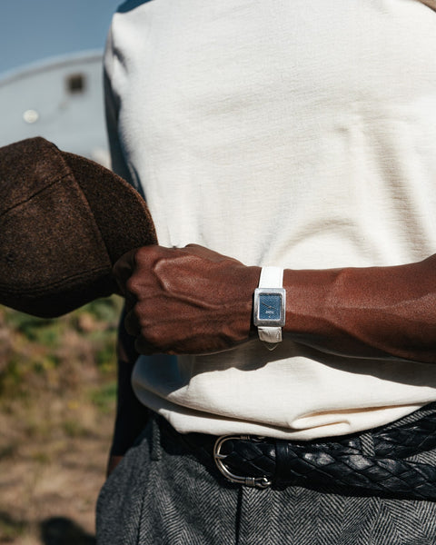 Nature 215 loopwheeled t-shirt tucked into grey herringbone trousers with a braided leather belt
