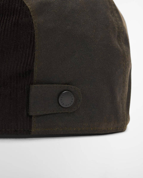 Close view of the tonal embroidery and waxed cotton on the olive Barbour Ashby flat cap.