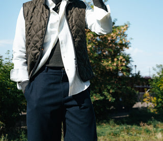 De Bonne Facture Navy Balloon Trousers in water repellent wool, worn with a quilted vest
