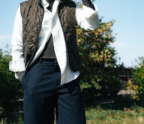 De Bonne Facture Navy Balloon Trousers in water repellent wool, worn with a quilted vest