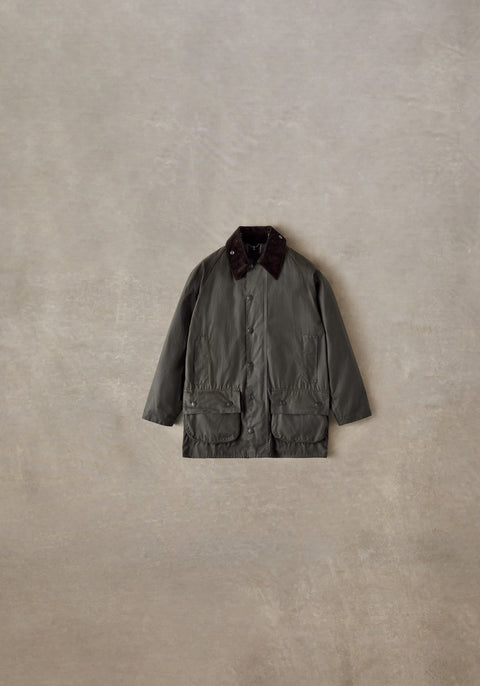 Barbour Olive Classic Beaufort Wax Jacket styled flat on a stone backdrop.