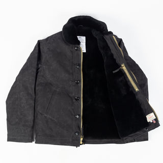 Black/Black waxed canvas N-1 Deck Jacket with black mouton collar, open, showing the black mouton lining and zipper