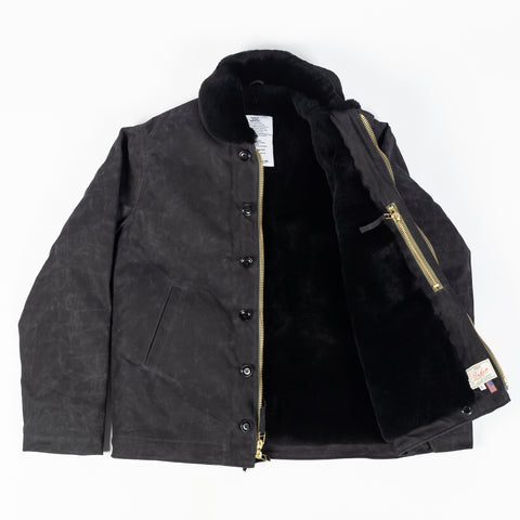 Black/Black waxed canvas N-1 Deck Jacket with black mouton collar, open, showing the black mouton lining and zipper