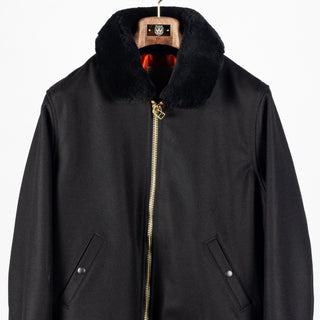 Black melton wool Flyer's Club Jacket with black mouton collar, front, close view of the zipper and pockets