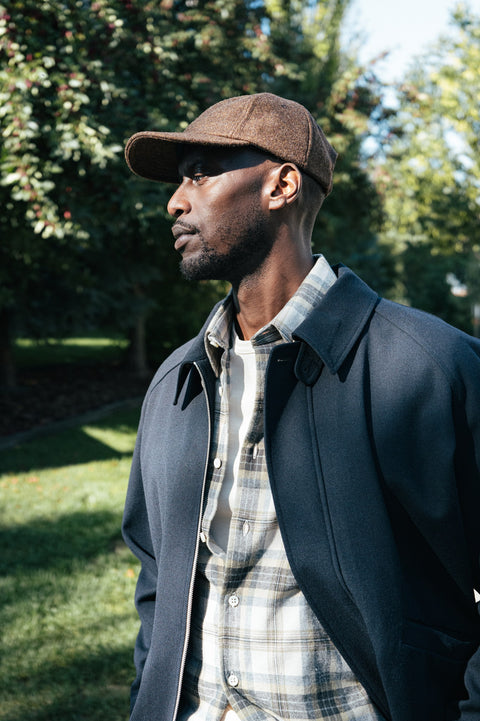 Dehen Dark Tan Mix Unstructured Baseball Hat worn with a plaid shirt and navy jacket