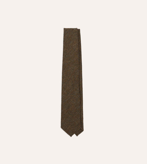 Drake's brown and black Shetland herringbone wool tie laid flat, full length.