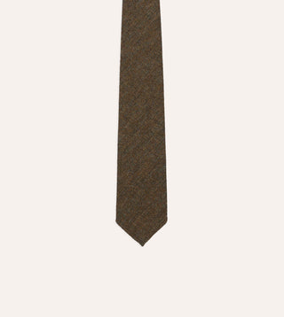 Blade and point of Drake's brown and black herringbone wool tie, close on the weave.