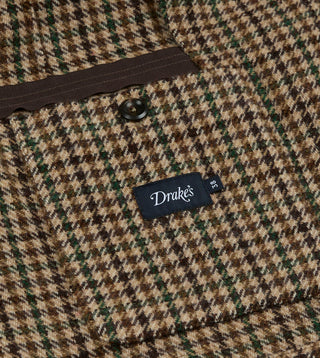 Inside of Drake's Brown and Green Houndstooth Tweed Games Blazer with a buttoned inner pocket and the Drake's size label.