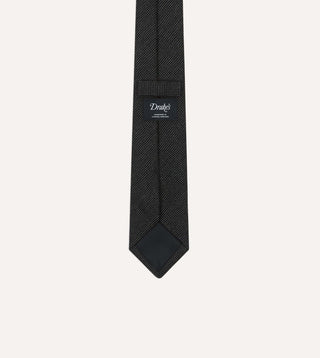 Back of the Drake's oxford weave wool tie showing the woven label, self loop and tipping
