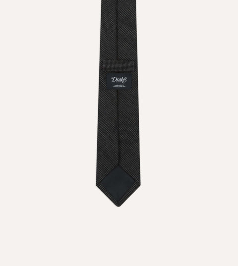 Back of the Drake's oxford weave wool tie showing the woven label, self loop and tipping