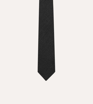 Close view of the oxford weave pin dot cloth and pointed tip of the Drake's wool tie