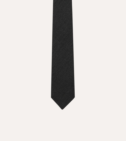 Close view of the oxford weave pin dot cloth and pointed tip of the Drake's wool tie