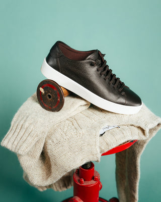 Harley of Scotland Portland Cable Crew Neck Sweater shown with a leather sneaker