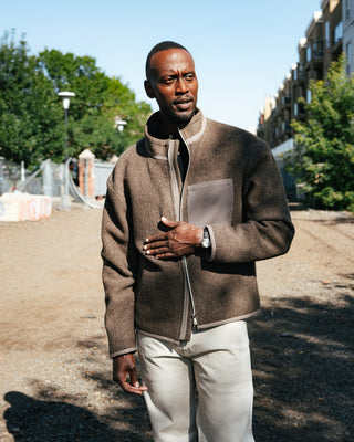 AG Tellis Selvage Marble Tan Denim worn under a shearling bomber