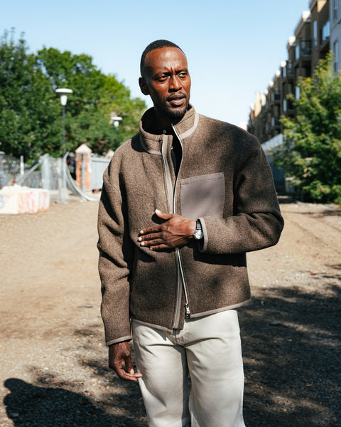 AG Tellis Selvage Marble Tan Denim worn under a shearling bomber