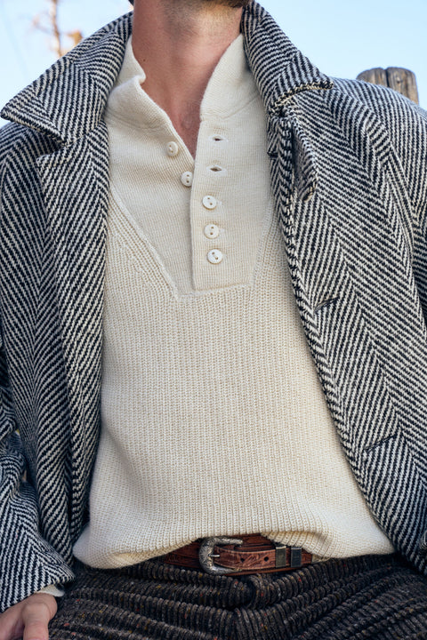Wythe black and cream herringbone raglan overcoat worn open over a cream henley
