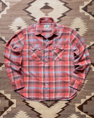 Wythe Cactus Flower Plaid washed flannel pearlsnap shirt laid flat on a rug