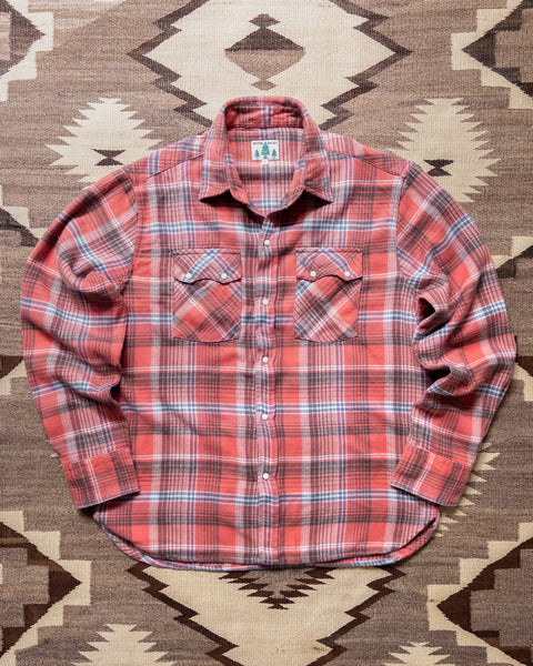 Wythe Cactus Flower Plaid washed flannel pearlsnap shirt laid flat on a rug