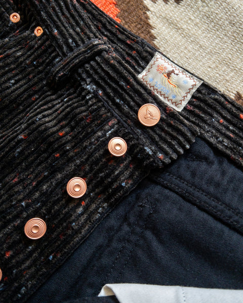 Copper button fly and waist label on the Night Sky Donegal corduroy pants