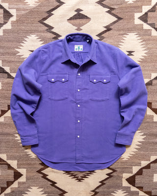 Wythe purple moleskin pearlsnap shirt laid flat on a rug